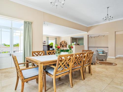 a dining room with a table and chairs at Chandler Heights in Knysna
