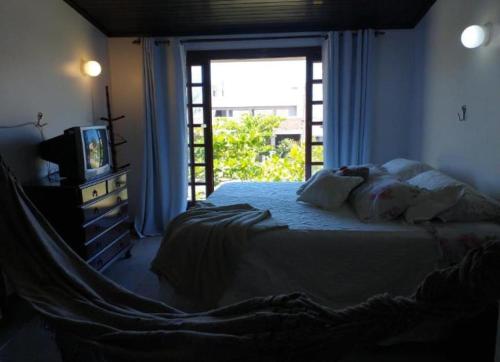 Giường trong phòng chung tại Casa capão da canoa