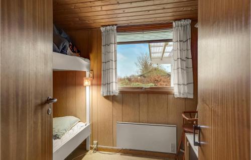 a small room with a window and a bed at Holiday Home Haslevgårde Bakker Hadsund Xii in Haslevgårde