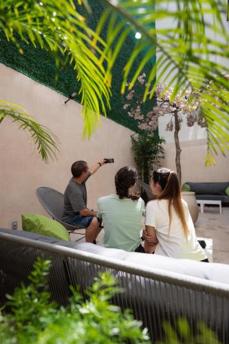 a group of people sitting on a bench at SUUT Hostal Boutique in Playa del Carmen