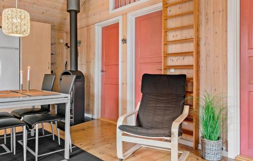 a dining room with a table and chairs and a stove at 3 Bedroom Nice Home In Kibæk in Kibæk
