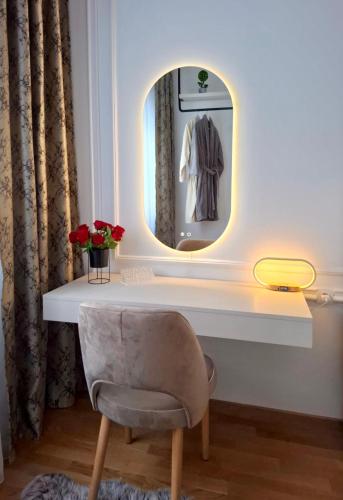 a dressing room with a chair and a mirror at Monte Relax - Wellness Oase in Zlatibor
