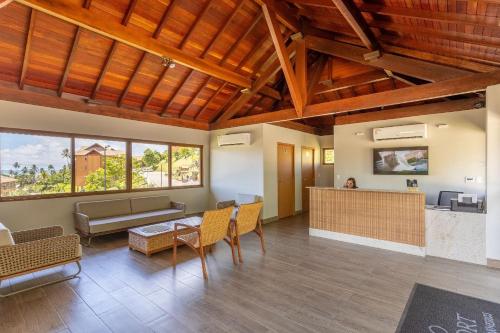 a living room with a couch and a table at Flat Colina - Eco Resort Praia dos Carneiros in Tamandaré