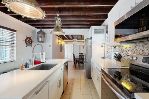 a large kitchen with white counters and a sink at La Pirata in Marathon