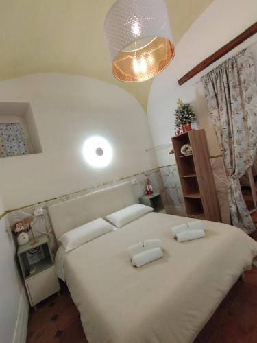 a bedroom with a large white bed with two pillows at Siconolfo 5 in Salerno