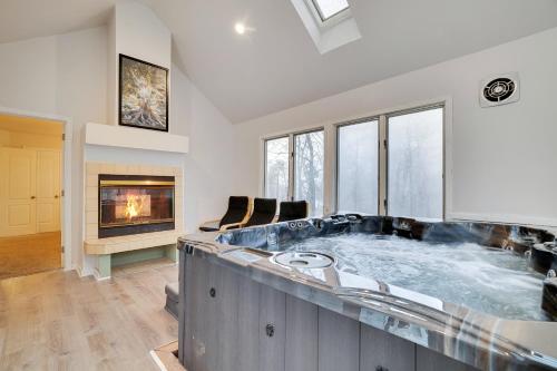 a large bath tub in a room with a fireplace at Lake Harmony Retreat Perfect Family Getaway in Lake Harmony