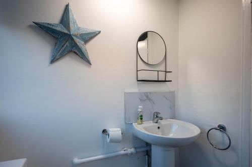 a bathroom with a sink and a star on the wall at Entire 3 Bedroom Apartment in Felixstowe in Felixstowe