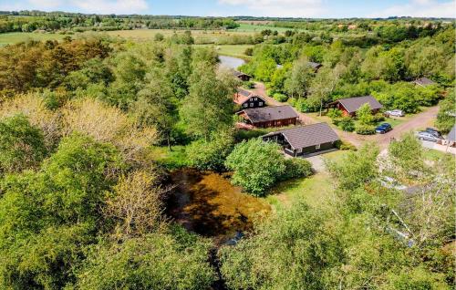 an aerial view of a house in the trees at 3 Bedroom Nice Home In Kibæk in Kibæk