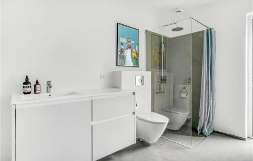 a white bathroom with a sink and a toilet at Beautiful Home In Sjællands Odde in Yderby
