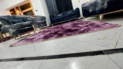 a purple rug on the floor in a room with chairs at Stanley 45 in Alexandria