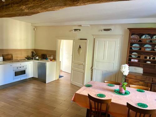 a kitchen with a table with a vase of flowers on it at Grand family home in the heart of Burgundy! in Saint-Berain-sur-Dheune