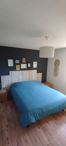 Ce lit bleu se trouve dans une chambre dotée de parquet. dans l'établissement Villa Mara, à Lorgues