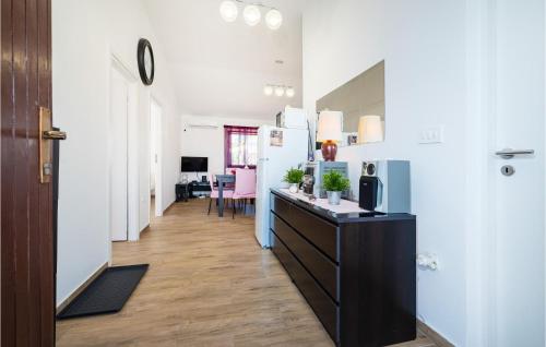 a kitchen with a black counter and a refrigerator at Lovely Apartment In Maslenica in Maslenica
