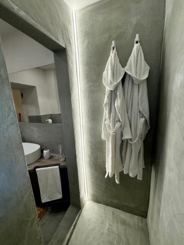 a bathroom with white towels hanging on a wall at La città d'oro apartments in Arezzo