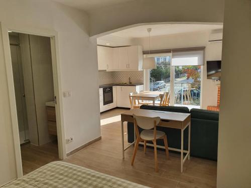 a kitchen and living room with a table and a couch at Casa da Conceição in Vila Real