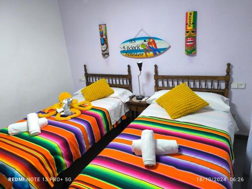 two beds with stuffed animals on them in a room at Bonito apartament a 3 minutos de la playa in Cullera