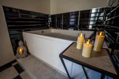 a bathroom with candles on a table next to a tub at Antica Dogana in Sarzana
