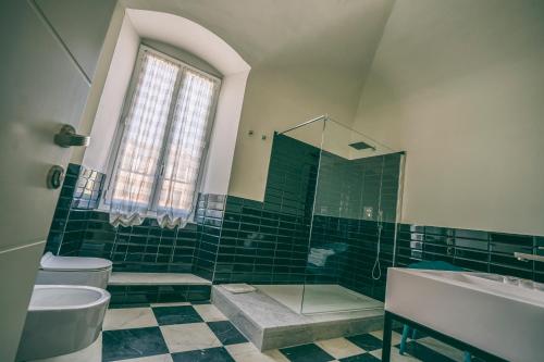 a bathroom with a tub and a toilet and a sink at Antica Dogana in Sarzana