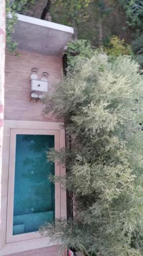 a house with a bird feeder on the side of it at Riad Tazawa in Ibrahene