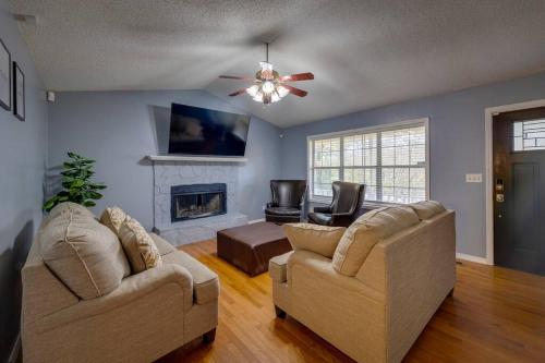 a living room with two couches and a fireplace at Oasis by JSU and McLellan Yahou Lake in Anniston