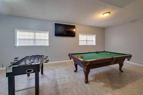 a room with a pool table and a tv at Oasis by JSU and McLellan Yahou Lake in Anniston