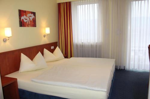 Katil atau katil-katil dalam bilik di Park Hotel Rüdesheim