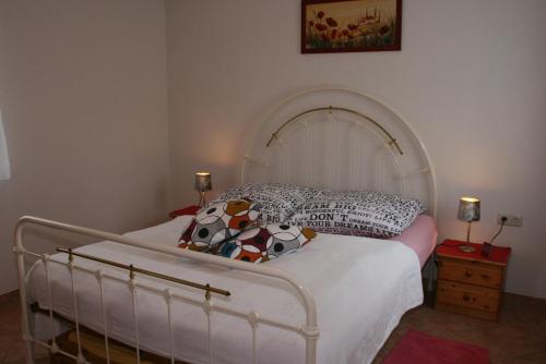 a bedroom with a white bed with pillows on it at Ferienhaus "Kleiner Schoner" in Rerik