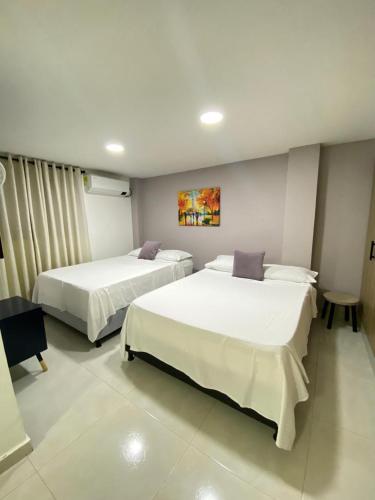 a hotel room with two beds in a room at Amoblados la 19 in Ríohacha