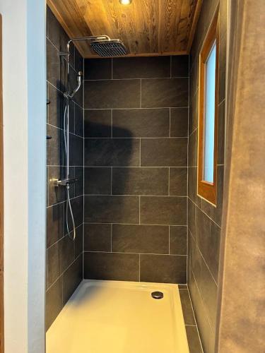 a bathroom with a shower with a shower at Hôtel des Muverans in Ovronnaz