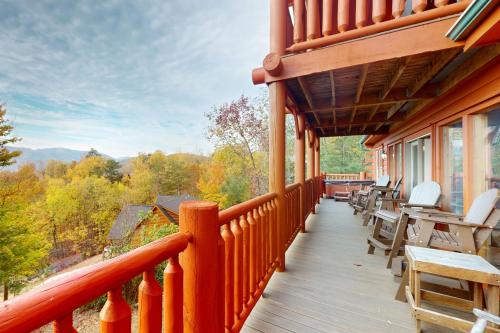 a balcony of a house with tables and chairs at Million Dollar View Cabin in Dupont Springs