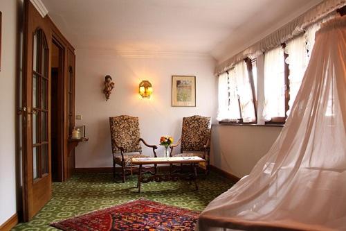 a room with two chairs and a table and a window at Schwarzwaldhotel Stollen in Gutach im Breisgau