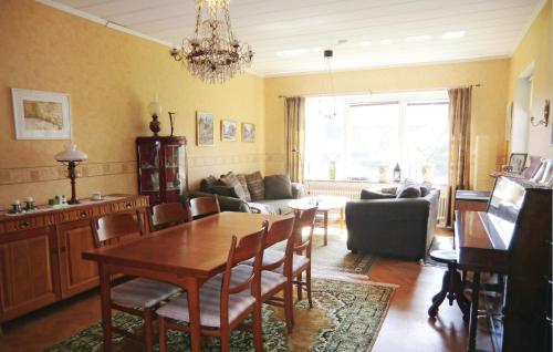 a living room with a table and a dining room at 4 Bedroom Stunning Home In Helsingborg in Helsingborg