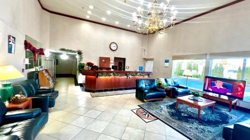 a large living room with couches and a tv at Studio 6 Suites Portland, OR Downtown OHSU in Portland