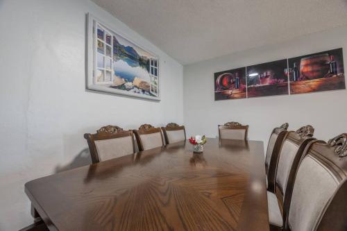 a dining room with a wooden table and chairs at Peaceful in Royal Palm Beach