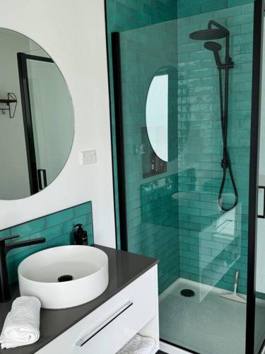 a bathroom with a sink and a glass shower at Main Street Retreat in Greytown