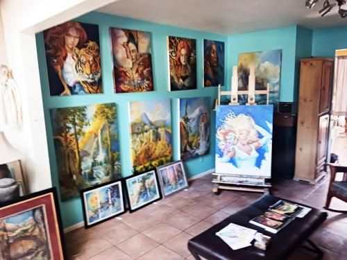 a room with a bunch of paintings on the wall at Randy's Roost in Santa Fe