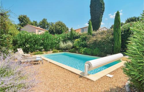 a swimming pool with a slide in a garden at Amazing Home In Saint Remy De Provence in Saint-Rémy-de-Provence