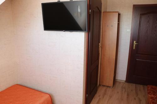 a flat screen tv hanging on a wall in a room at Zajazd Żubryn in Zubryn