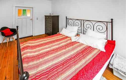 a bedroom with a large bed with a red blanket at Ferienwohnung Kieve in Kieve