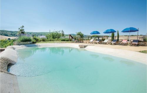 a large pool of blue water with chairs and umbrellas at La Casa Della Fata in Montenero