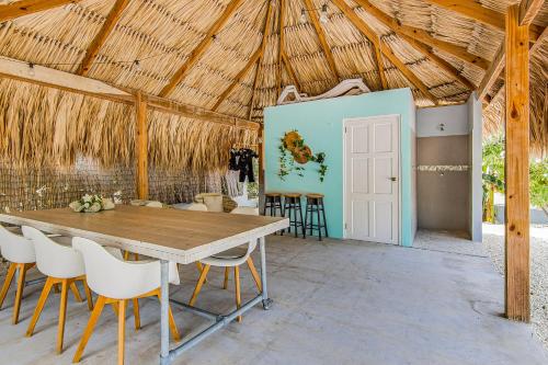 a dining room with a wooden table and chairs at Paradise Apartments - Curacao in Fontein