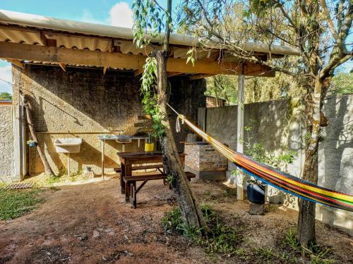 a building with a hammock in front of it at Casa Container á 3minutos da Lagoa in Tapes