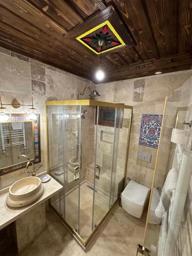 a bathroom with a shower and a toilet at Saint Johns Hill Boutique Ephesus in Selcuk