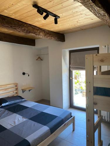 a bedroom with a bed with a wooden ceiling at Casa Nigritella in Ornavasso
