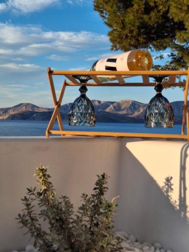 a table on a wall with a view of the water at Aegean Whisper in Masouri