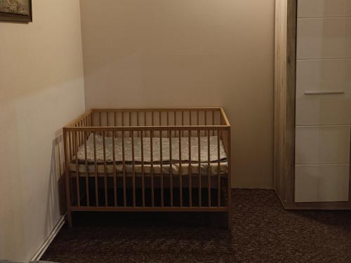 a crib in the corner of a room at Apartments " VINTAGE " Teplice in Teplice