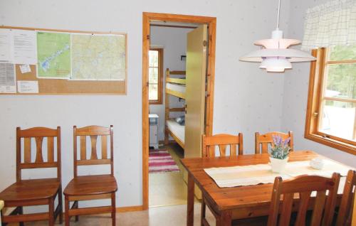 a dining room with a wooden table and chairs at Gorgeous Home In Gislaved With Wifi in Våthult