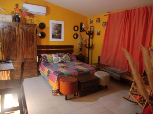 a bedroom with a bed and a red curtain at El REFUGIO DE KARIM in San Rafael