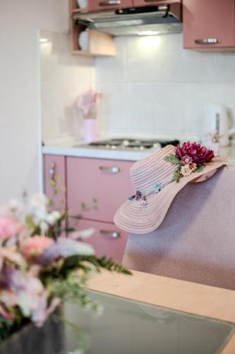 a wooden spoon with flowers on the counter in a kitchen at Apartment Milna - with Swimming Pool & Amazing Seaviews, above Bijaka Beach in Milna