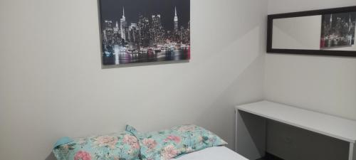 a bedroom with a bed and two pictures on the wall at Hostel Blaese Pascal - HBP in Guarulhos